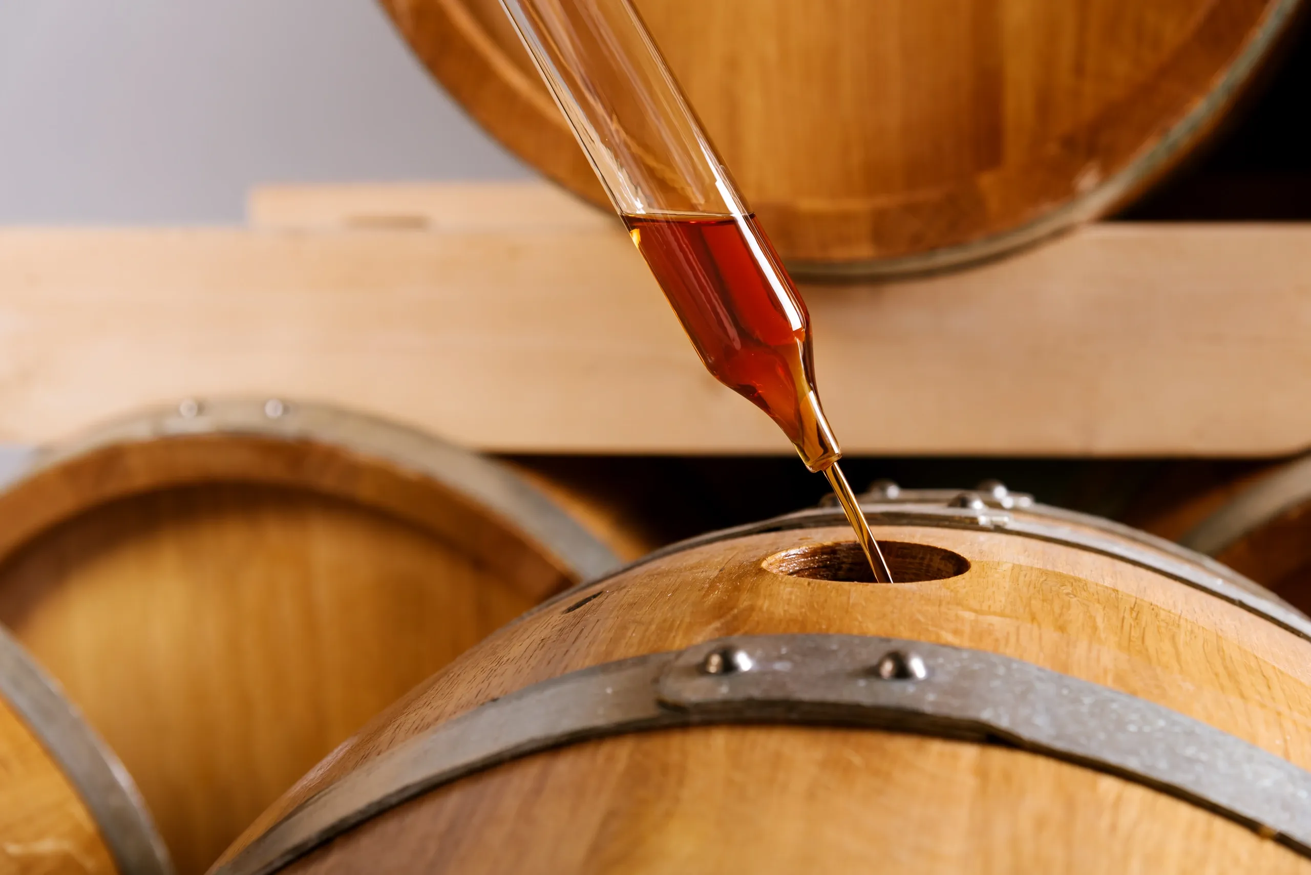 Barrel being filled with brown liquid.